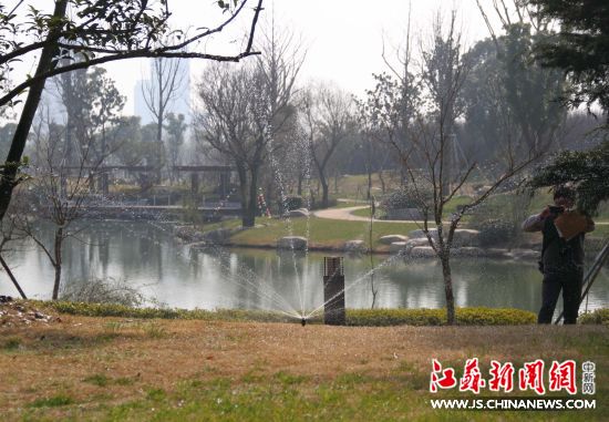 工作人员用景观湖里的水浇灌绿化2